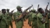 FILE - South Sudanese rebel soldiers raise their weapons at a military camp in the capital, Juba, South Sudan, April 7, 2016.
