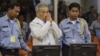 FILE - Former Khmer Rouge S-21 prison chief Duch (C) greets the court during his appeal hearing at the Court Room of the Extraordinary Chambers in the Courts of Cambodia (ECCC) on the outskirts of Phnom Penh, Feb. 3, 2012. 