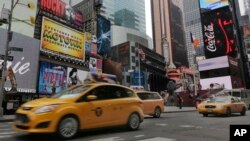 FILE — New York City taxis pass through New York's Times Square.