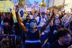Demonstrators protest, Thursday, June 4, 2020, near the White House in Washington, over the death of George Floyd, a black man who was in police custody in Minneapolis. Floyd died after being restrained by Minneapolis police officers.