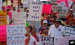 Protesters for women's rights march to the Alabama Capitol to protest a law passed last week making abortion a felony in nearly all cases with no exceptions for cases of rape or incest, May 19, 2019, in Montgomery, Ala.