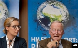 FILE - Alice Weidel and Alexander Gauland, top candidates of the German AfD (Alternative for Germany) party in the general election, attend a press conference in Berlin, Germany, Aug. 21, 2017.