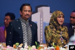 FILE - Brunei Sultan Hassanal Bolkiah, left, and wife Queen Saleha attends the Gala Dinner at the 27th ASEAN Summit in Kuala Lumpur, Malaysia.