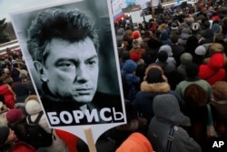 People gather in St. Petersburg, Russia, to commemorate the 2015 slaying of opposition leader Boris Nemtsov, Feb. 27, 2016.