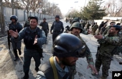 FILE - Security forces inspect the site of an Islamic State-claimed attack on a hospital in Kabul, Afghanistan, March 8, 2017.