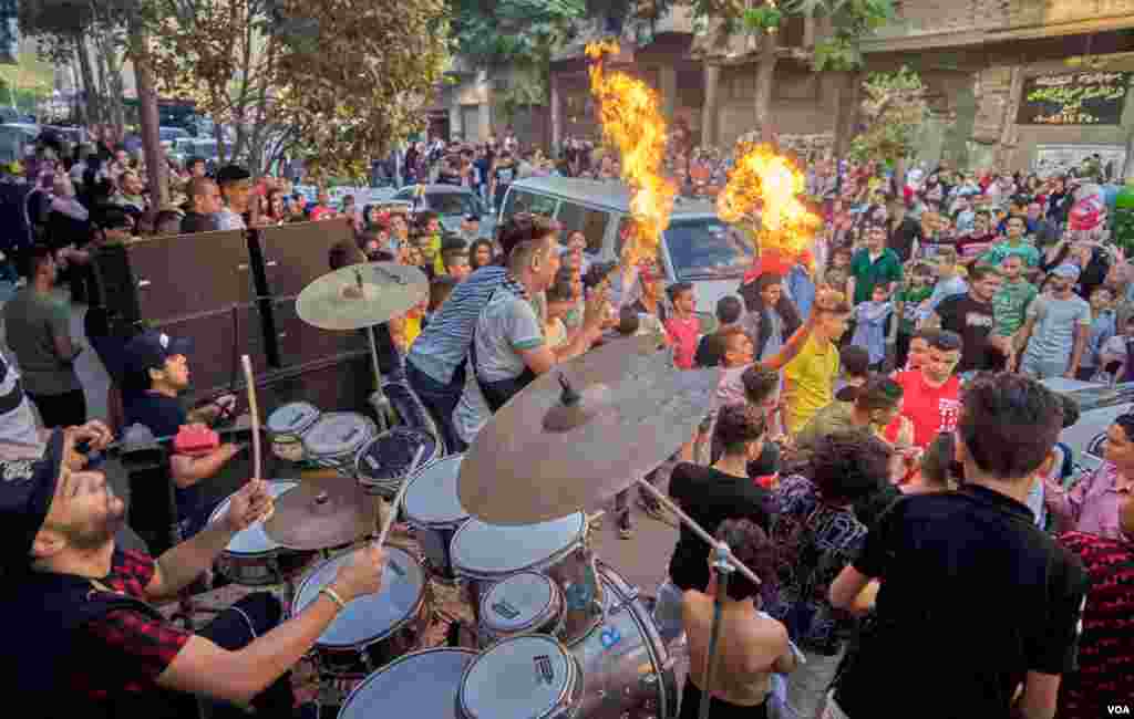 After finishing the prayers of Eid Al-Adha, young Egyptians gather for big streets dancing parties with DJ sound system and drums, in Old Cairo. (H. Elrasam/VOA)