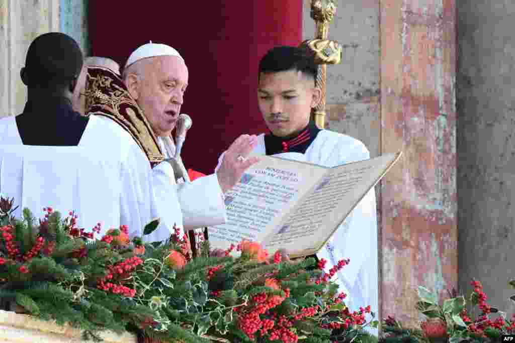 Pope Francis delivers the Urbi et Orbi message and blessing to the city and the world from the main balcony of St. Peter's basilica as part of Christmas celebrations, at St. Peter's square in the Vatican, Dec. 25, 2024.