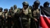 Kenyan police, who are part of a UN-backed multinational force, pray on the tarmac after landing at the Toussaint Louverture International Airport in Port-au-Prince, Haiti, Feb. 6, 2025. 