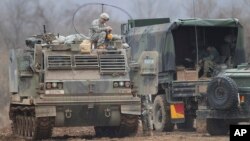 A U.S. Army soldier sits on an armored vehicle during an annual exercise in Yeoncheon, near the border with North Korea, Monday, March 7, 2016. 