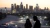 Pengunjung mengenakan masker saat mengamati lokasi vaksinasi COVID-19 di Stadion Dodger di Los Angeles, Jumat, 15 Januari 2021. (Foto AP / Marcio Jose Sanchez)
