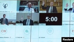 Amazon CEO Jeff Bezos, Facebook CEO Mark Zuckerberg, Google CEO Sundar Pichai and Apple CEO Tim Cook all raise their hands to be sworn in to testify remotely via videoconference during a U.S. House Judiciary Subcommittee on Antitrust, Commercial and Administrative Law hearing on 