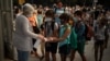 FILE - Students wearing face masks to prevent the spread of coronavirus disinfect their hands before entering their school in Barcelona, Spain, September 14, 2020. 