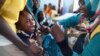A child receives a meningitis vaccination at the community center in El Daein, East Darfur, Sudan on October 8, 2012. 