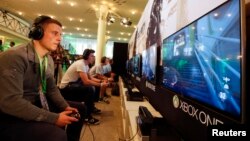 A gamer plays "Call of Duty: Advanced Warfare" on an Xbox One console during the Xbox Play Day 2014, before the Gamescom 2014 fair in Cologne August 12, 2014. The Gamescom convention, Europe's largest video games trade fair, is opened to the public from A