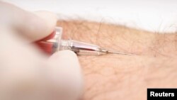 FILE - A nurse draws a blood sample during a testing campaign to prevent HIV infection in Bangkok, Sept. 20, 2014. 