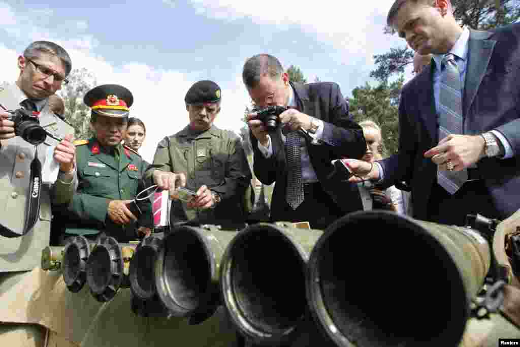 Foreign military attaches and media look at grenade launchers seized from pro-Russian separatists in the eastern regions of Ukraine, Aug. 29, 2014. 