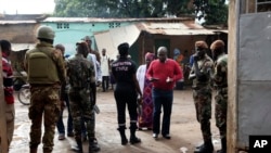 FILE - Security troops stand outside a polling station during the initial presidential elections in Bamako, Mali, July 29, 2018.