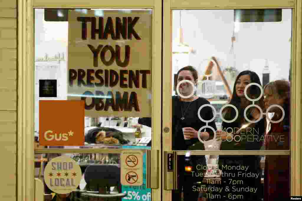 A shop has a sign in the window reading thank you to U.S. President Barack Obama, who was making a stop nearby on his way to deliver his farewell address in Chicago, Ill., Jan. 10, 2017.