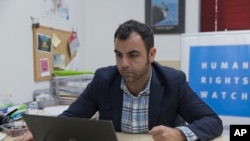 Omar Shakir, the local director of Human Rights Watch, works at his office in the West Bank city of Ramallah, Nov. 5, 2019.