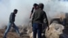 Kobani residents protest Turkish soldiers during a patrol inside Syria