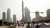 FILE - People wearing masks make their way in the Ryomyong street in Pyongyang, North Korea, July 3, 2020. 