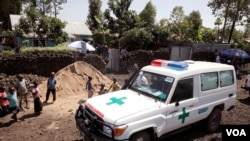 FILE - An ambulance waits next to a clinic to transport a suspected Ebola patient, in Goma, Democratic Republic of the Congo, Aug. 5, 2019.