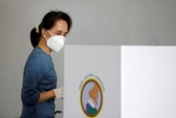 FILE - Myanmar State Counselor and de facto leader Aung San Suu Kyi arrives to vote early for the Nov. 8 general election, in Naypyitaw, Myanmar, Oct. 29, 2020. According to a party official, she and others have been detained in a morning raid.