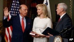 Hilary Ross, center, watches as Vice President Mike Pence swears-in new Commerce Secretary Wilbur Ross, Feb. 28, 2017, in the Vice President's ceremonial office in the Eisenhower Executive Office Building on the White House complex in Washington.