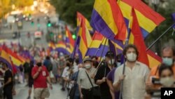 Demonstrators holding Republican flags march during a protest against the Spanish monarchy in Madrid, Spain, July 25, 2020. 