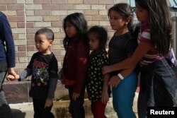 Children form a line as undocumented immigrant families are released from detention at a bus depot in McAllen, Texas, June 22, 2018.