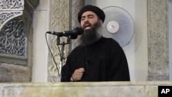 FILE - This image from video purports to show Islamic State leader Abu Bakr al-Baghdadi delivering a sermon in Iraq.