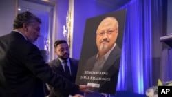 Mongi Dhaouadi (L) and Ahmed Bedier set up an image of slain Saudi journalist Jamal Khashoggi before an event to remember Khashoggi, a columnist for The Washington Post who was killed inside the Saudi Consulate in Istanbul on Oct. 2, in Washington, Nov. 2