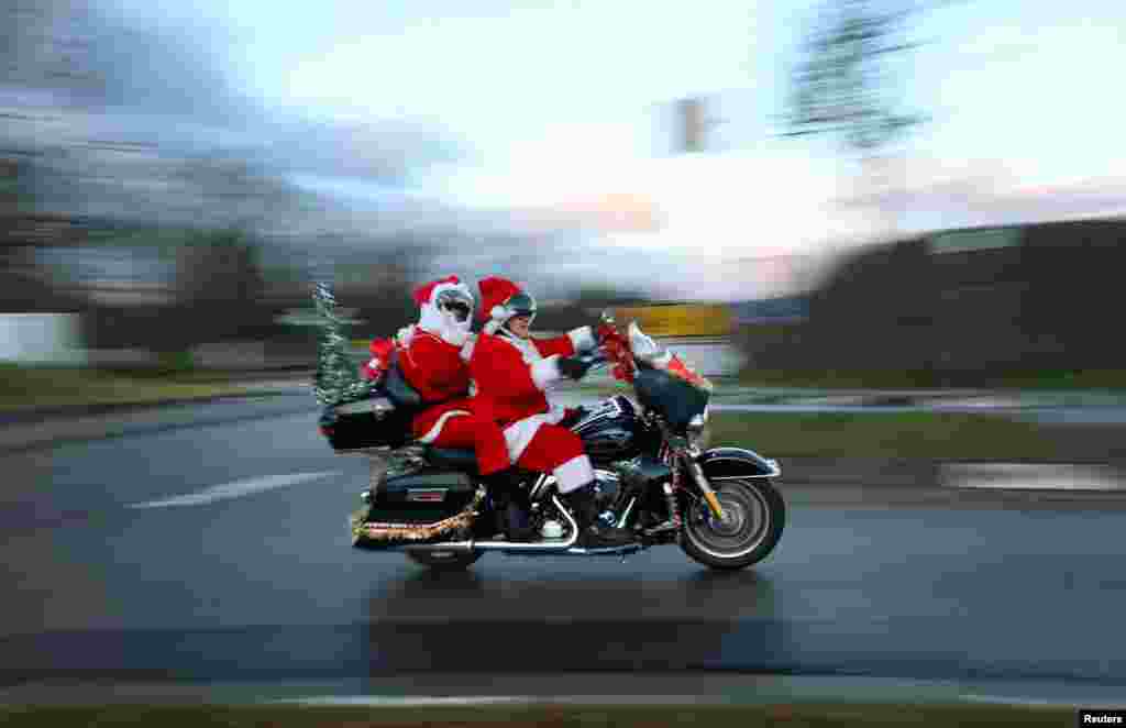 Members of the "Riding Santas" Harley Davidson club take part in their 10th ride to distribute sweets to children and collect money for a children's hospice in Jockgrim, near Neustadt an der Weinstrasse, Germany.