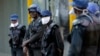 Riot police wear face masks on the streets of Harare, Zimbabwe, Tuesday, March 31, 2020. Zimbabwe went into a lockdown for 21 days in an effort to curb the spread of the coronavirus. The new coronavirus causes mild or moderate symptoms for most…