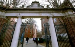 FILE - A gate opens to the Harvard University campus in Cambridge, Mass., Dec. 13, 2018.