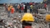 FILE - Rescue workers are seen on the site of a collapsed building in Lagos, Nigeria, Sept. 16, 2014.