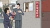 Female trader giving a bribe to a market supervisor in an alley near the market. Female traders have described offering bribes in order to avoid potential harassment.