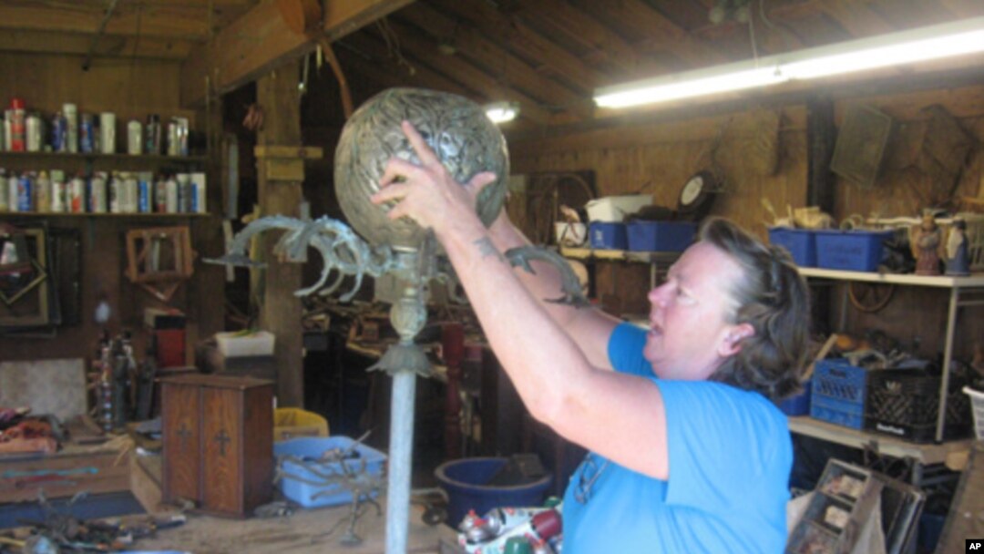 Mississippi artist Lori Gordon works on a new outdoor piece, made from almost all Katrina debris except for a few glass prisms and the hardware holding it together.