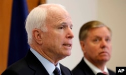 FILE - Republican presidential candidate Sen. Lindsey Graham, R-S.C. listens at right as former Republican presidential nominee, Sen. John McCain, R-Ariz. talks about his support for Graham during a campaign stop, Friday, Sept. 11, 2015, in Manchester, N