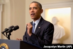 FILE - President Barack Obama speaks about the Paris climate agreement from the Cabinet Room of the White House in Washington, Dec 12, 2015.