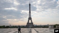 A man wears a mask to protect against the spread of the coronavirus as he walks along the Trocadero square close to the Eiffel Tower in Paris, France, April 25, 2020.