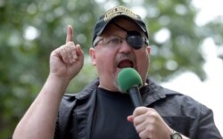 FILE - In this Sunday, June 25, 2017 file photo, Stewart Rhodes, founder of the citizen militia group known as the Oath Keepers speaks during a rally outside the White House in Washington.