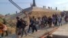 Lebih dari 260 warga asing diselamatkan dari operasi penipuan oleh kelompok bersenjata Myanmar, DKBA, dan diserahkan kepada otoritas Thailand di Phop Phra, pada 12 Februari 2025. (Foto: Courtesy DKBA)