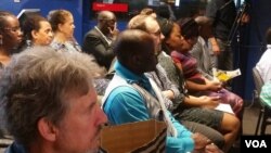 Participants following a discussion at a town hall organized by Studio 7 in USA.
