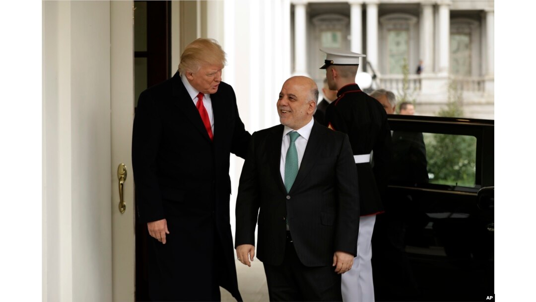 President Donald Trump, left, greets Iraqi Prime Minister Haider al-Abadi upon his arrival to the White House in Washington, March 20, 2017.