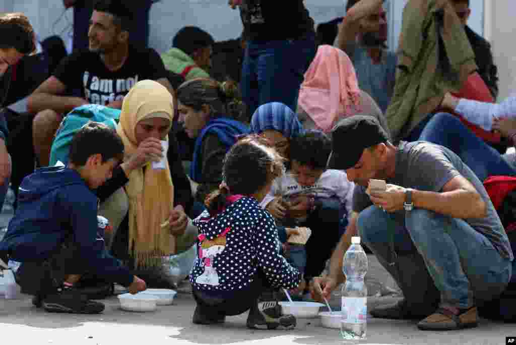 Migrants and refugees wait in Nickelsdorf, Austria, at the border between Hungary and Austria.
