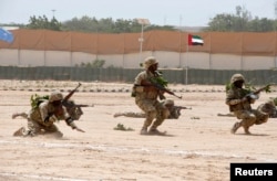 FILE - Members of the Somali military perform a defensive drill after attending a commando training exercise at the United Arab Emirates military training camp in the capital Mogadishu, Somalia, Jan. 20, 2016.