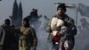 Syrians evacuated from the embattled Syrian city of Aleppo during the cease-fire arrive at a refugee camp in Rashidin, near Idlib, Syria, early Monday, Dec. 19, 2016.