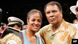 Laila Ali, left, poses with her father, boxing great Muhammad Ali, after her win against Erin Toughill, June 11, 2005.