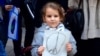 A girl holds a ‘Peace for Paris’ symbol, created by graphic designer Jean Jullien, at a vigil outside the French consulate in Chicago, Ill., Nov. 15, 2015.. 